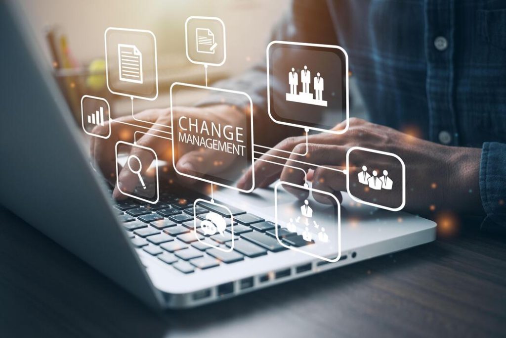 businessman using a computer to document change management in organization and business concept with consultant presenting icons of strategy organizational transition and transformation photo